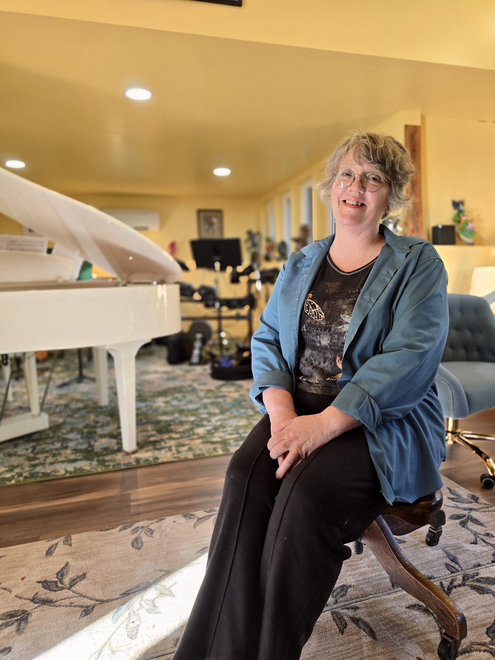 Karyn Grace sitting in her music studio